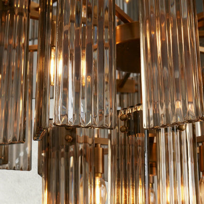 Lampthe Delsie Collection chandelier with reeded glass panels and steel frame, radiating old Hollywood glamour.